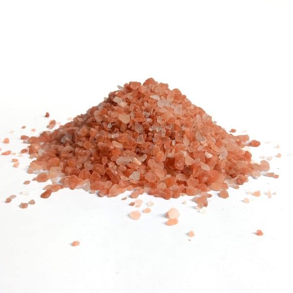 Pile of Himalayan Dark Pink Coarse Salt Crystals on White Background